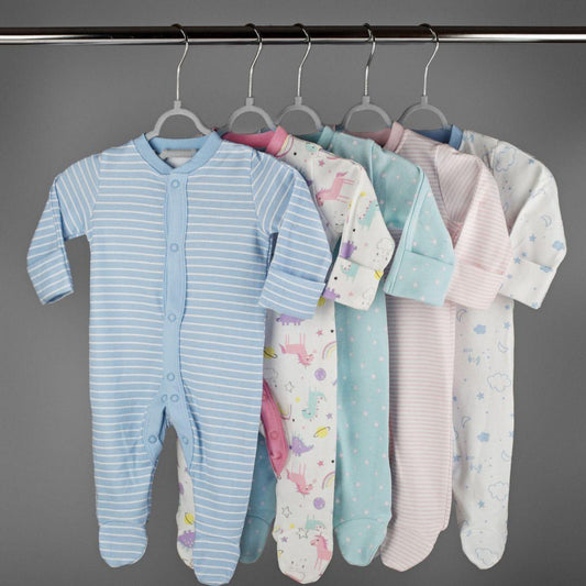 boys and girls baby onsies neatly hung from a clothing rack 